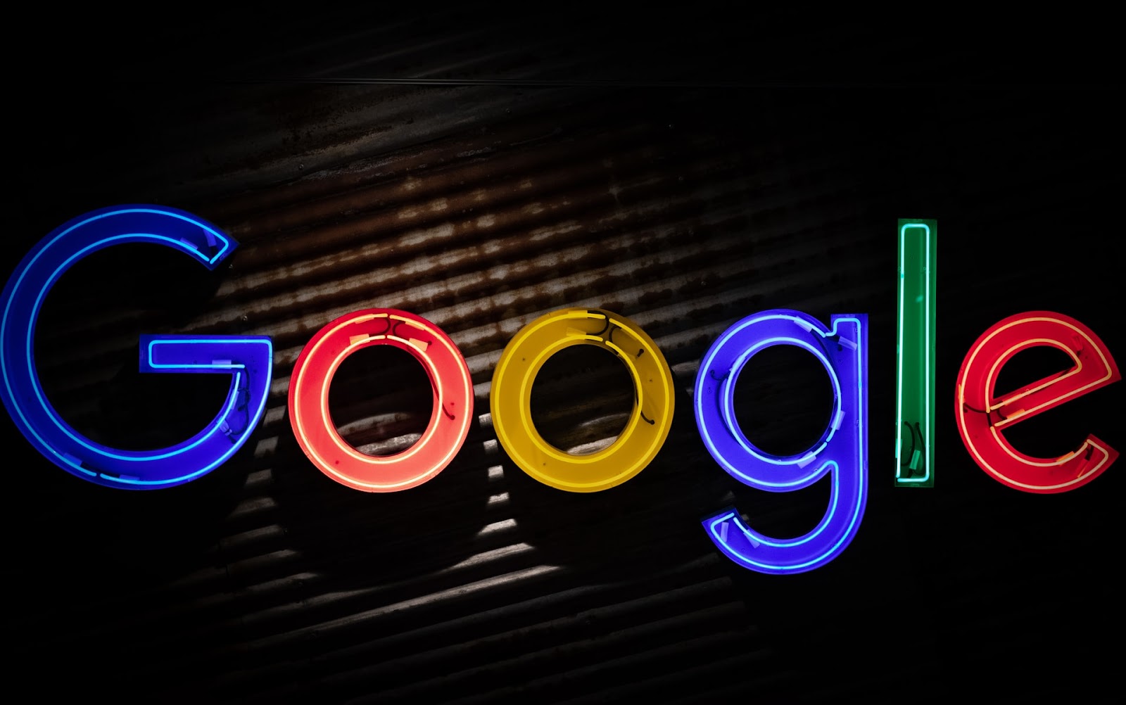 Neon electronic signage in electric blue with Google text, showcasing font style.