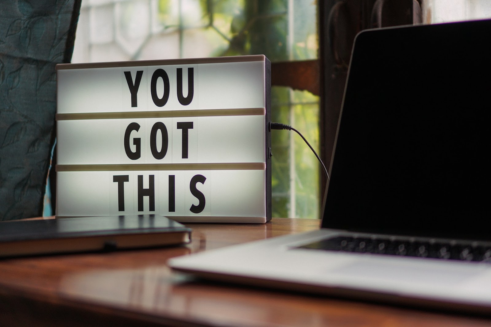 Text "YOU GOT THIS" displayed on a laptop screen.