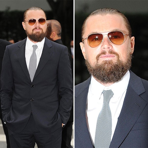 Person wearing sunglasses with a tie and outerwear, showcasing a trendy hairstyle with a vision care aspect.