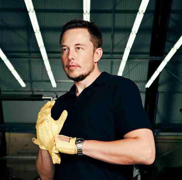 Person wearing a baseball glove on the left hand and a casual top on the right hand.